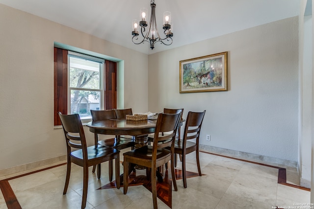 dining room with a notable chandelier and light tile patterned floors