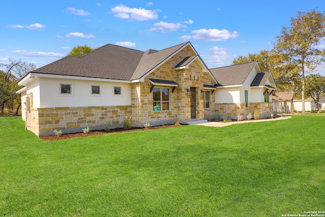 view of front of house with a front yard and a garage