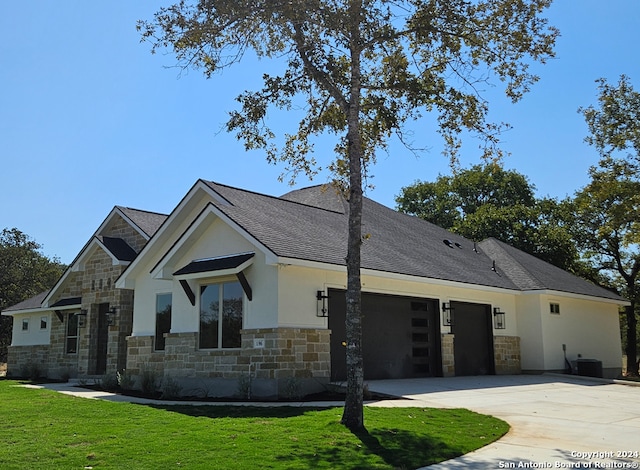 view of front of property with a front yard and a garage