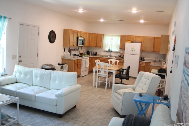 tiled living room featuring sink