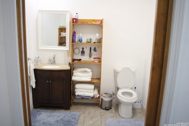 bathroom featuring tile patterned floors, toilet, and vanity