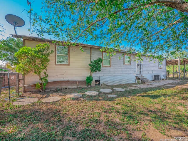 back of property featuring central AC unit