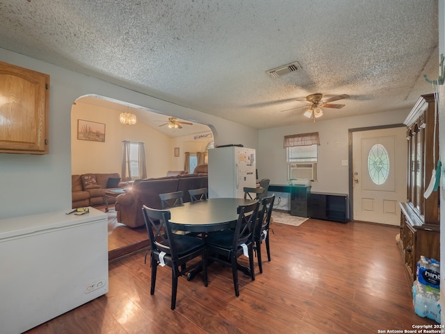 dining space featuring ceiling fan, hardwood / wood-style floors, a textured ceiling, and a healthy amount of sunlight