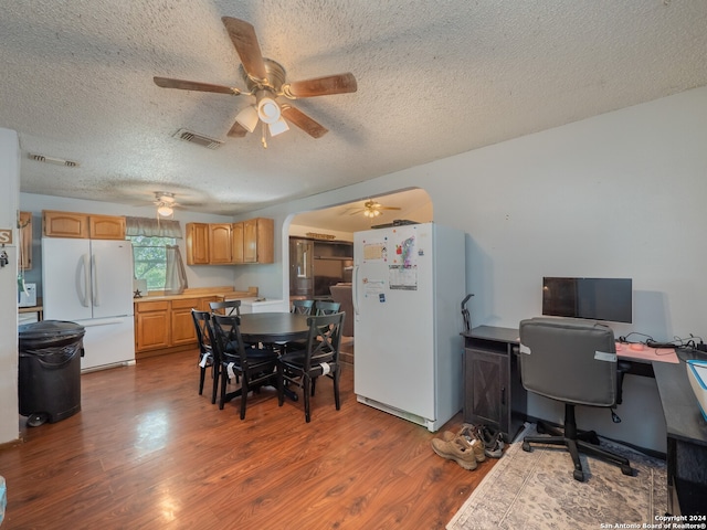 dining room with dark hardwood / wood-style flooring and a textured ceiling