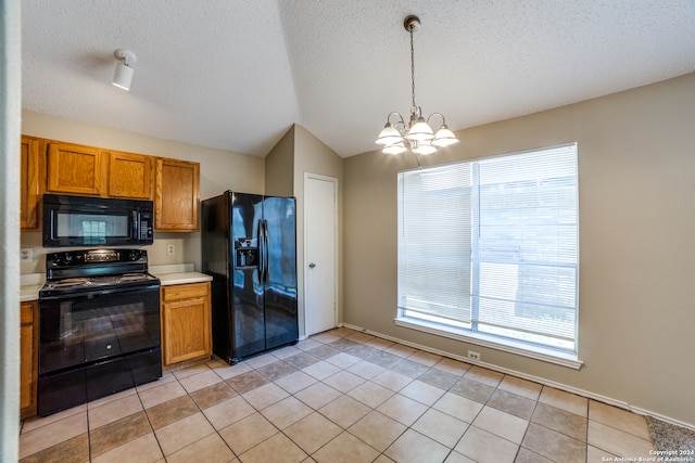 kitchen featuring an inviting chandelier, plenty of natural light, vaulted ceiling, and black appliances