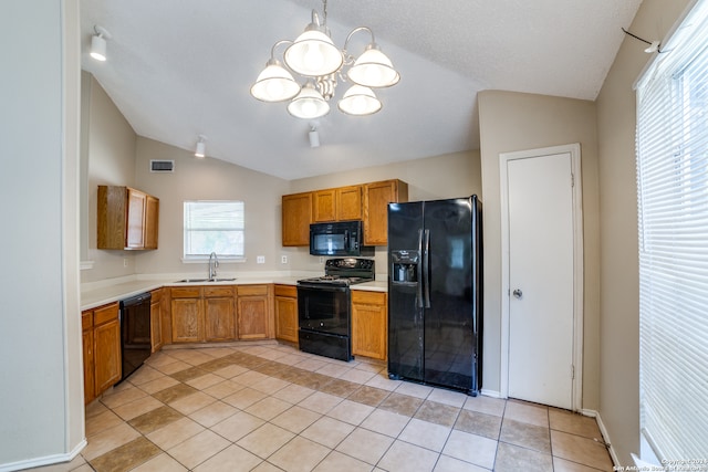 kitchen with sink, plenty of natural light, vaulted ceiling, and black appliances