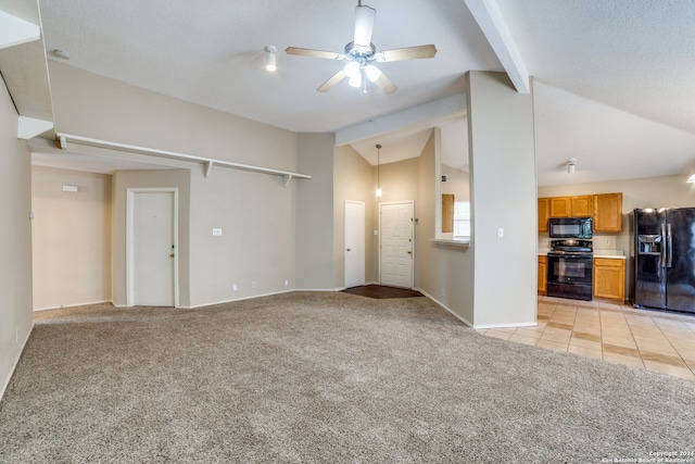 unfurnished living room with ceiling fan, light colored carpet, a textured ceiling, and lofted ceiling