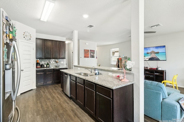 kitchen featuring dark wood-type flooring, appliances with stainless steel finishes, sink, and dark brown cabinets