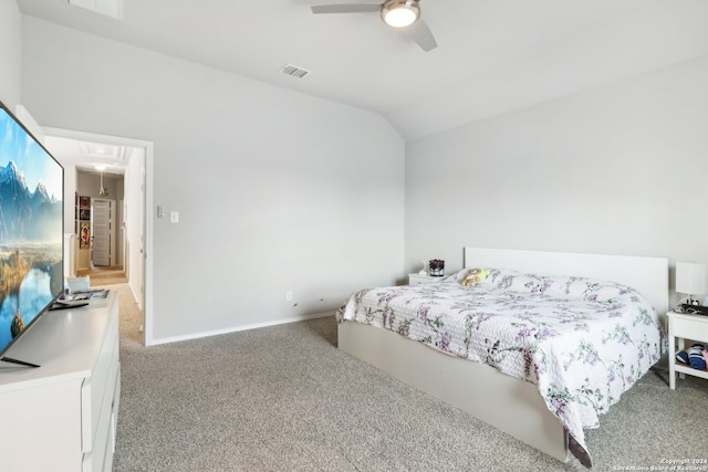 carpeted bedroom with ceiling fan and vaulted ceiling