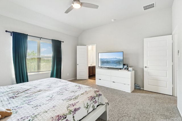 bedroom with lofted ceiling, ceiling fan, ensuite bathroom, and light colored carpet