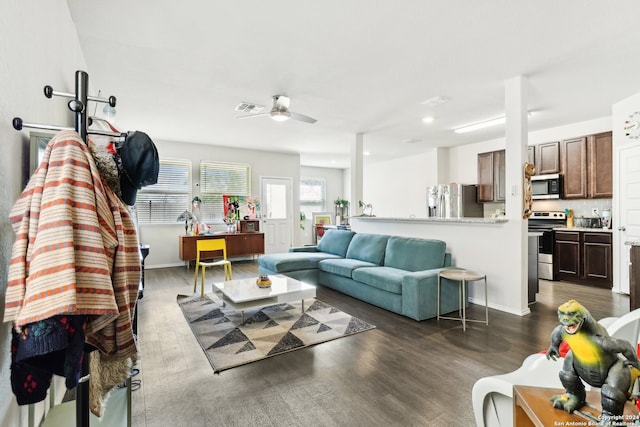 living room with dark hardwood / wood-style floors and ceiling fan