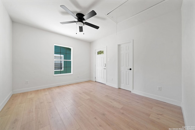 spare room with ceiling fan and light wood-type flooring