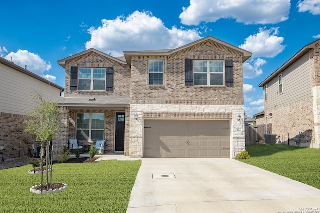 view of front of home with a garage, a front lawn, and central AC