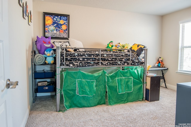 carpeted bedroom with multiple windows