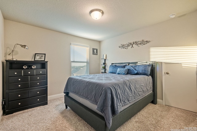 carpeted bedroom featuring a textured ceiling