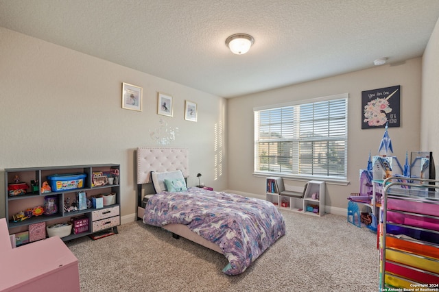 bedroom featuring carpet and a textured ceiling