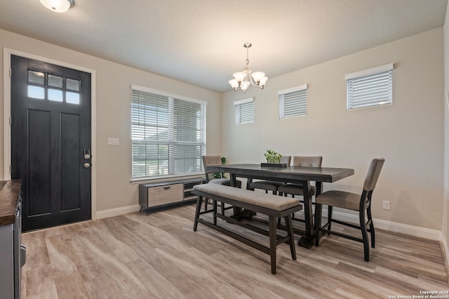 232 Wickersham, Boerne, TX 78015 - dining area featuring baseboards, a chandelier, and light wood finished floors