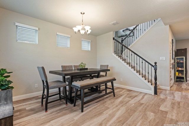 232 Wickersham, Boerne, TX 78015 - dining space with stairway, baseboards, an inviting chandelier, and light wood finished floors