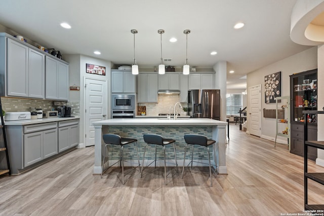 232 Wickersham, Boerne, TX 78015 - kitchen with a sink, appliances with stainless steel finishes, a breakfast bar area, and backsplash