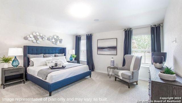 carpeted bedroom with baseboards