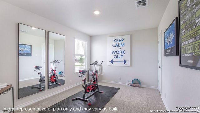 exercise area featuring baseboards, visible vents, carpet floors, and recessed lighting