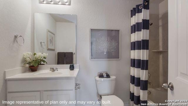 bathroom featuring shower / tub combo, vanity, and toilet
