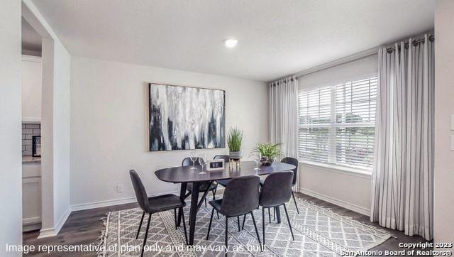 dining area featuring baseboards and wood finished floors