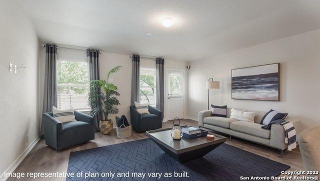 living room with baseboards and wood finished floors