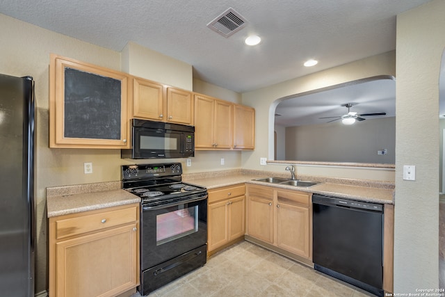 kitchen with black appliances, sink, and light brown cabinets