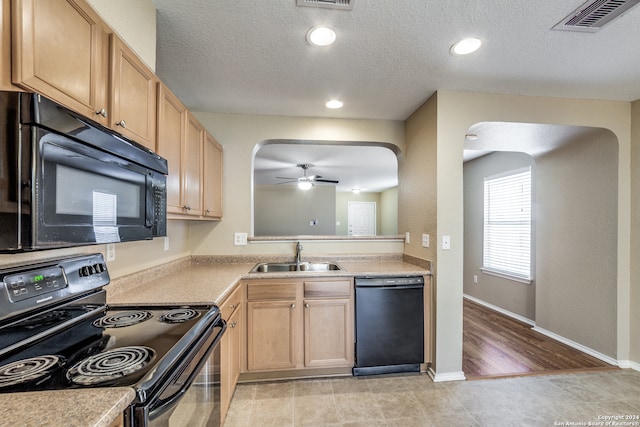 kitchen with ceiling fan, light brown cabinets, sink, black appliances, and light hardwood / wood-style floors
