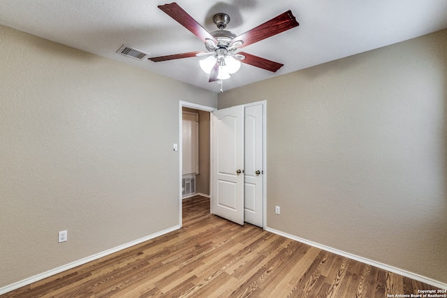 unfurnished bedroom featuring ceiling fan and light hardwood / wood-style floors