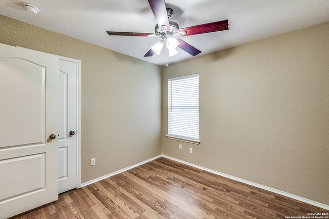 unfurnished room with ceiling fan and hardwood / wood-style floors