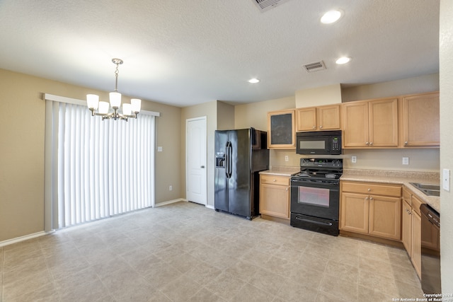 kitchen featuring pendant lighting, light brown cabinets, black appliances, and a notable chandelier