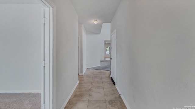 hallway featuring light carpet