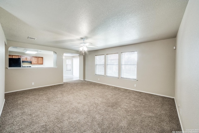 2815 Bandbury Oak, San Antonio, TX 78247 - spare room with arched walkways, carpet, a textured ceiling, and a ceiling fan