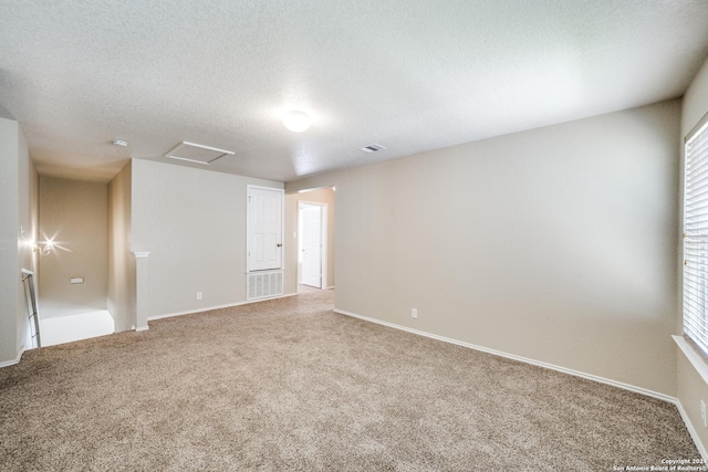 2815 Bandbury Oak, San Antonio, TX 78247 - carpeted empty room with baseboards, a textured ceiling, attic access, and a healthy amount of sunlight