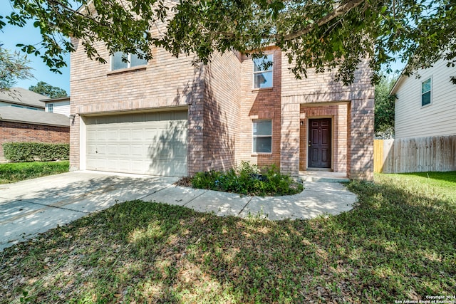 view of front of house featuring a garage and a front lawn