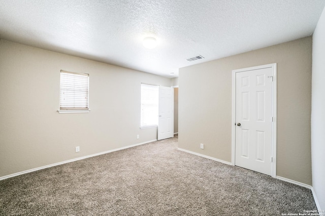 2815 Bandbury Oak, San Antonio, TX 78247 - unfurnished bedroom featuring visible vents, baseboards, carpet flooring, and a textured ceiling