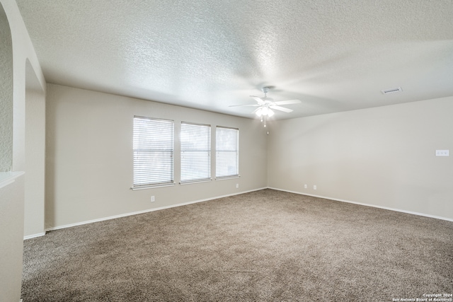 unfurnished room featuring ceiling fan, carpet, and a textured ceiling