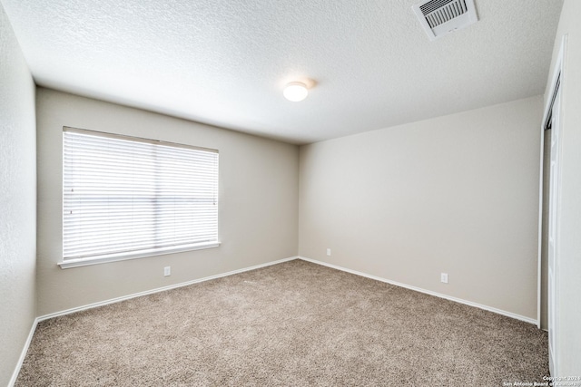 2815 Bandbury Oak, San Antonio, TX 78247 - empty room with carpet, visible vents, baseboards, and a textured ceiling