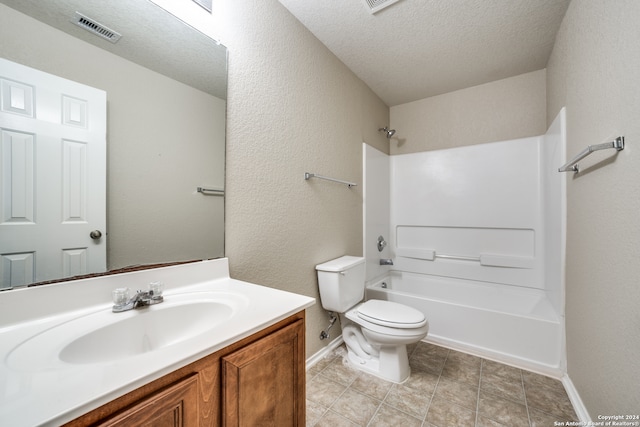 full bathroom with vanity, a textured ceiling, washtub / shower combination, tile patterned floors, and toilet