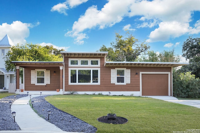 view of front of property with a garage and a front yard