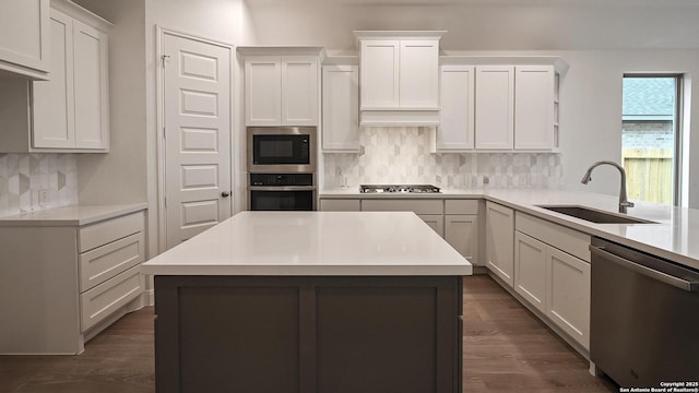 kitchen with appliances with stainless steel finishes, sink, and white cabinets