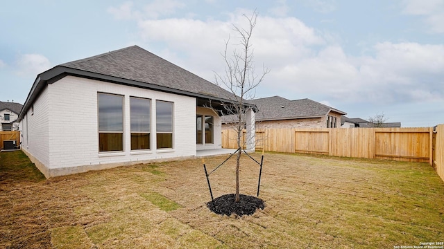 rear view of property featuring a yard