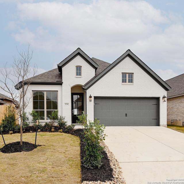 view of front of house featuring a garage and a front lawn