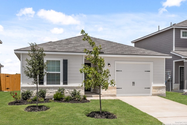 view of front of house with a garage and a front lawn