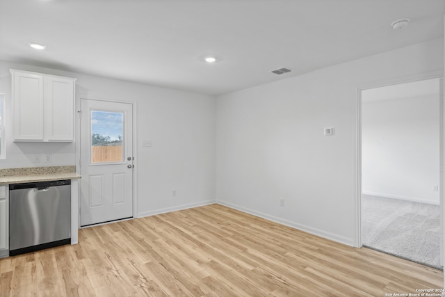 kitchen with light hardwood / wood-style floors, white cabinetry, and stainless steel dishwasher