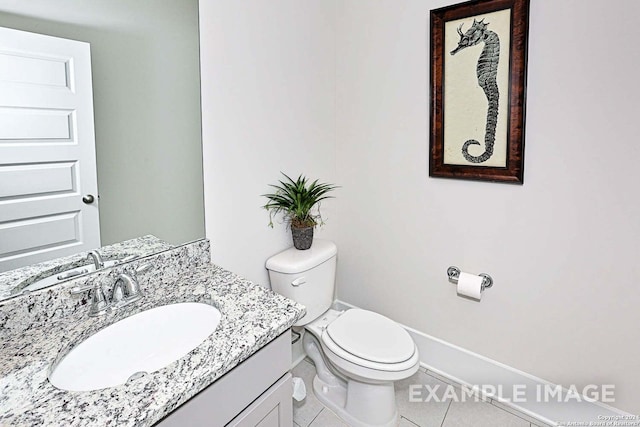 bathroom featuring vanity, tile patterned flooring, and toilet