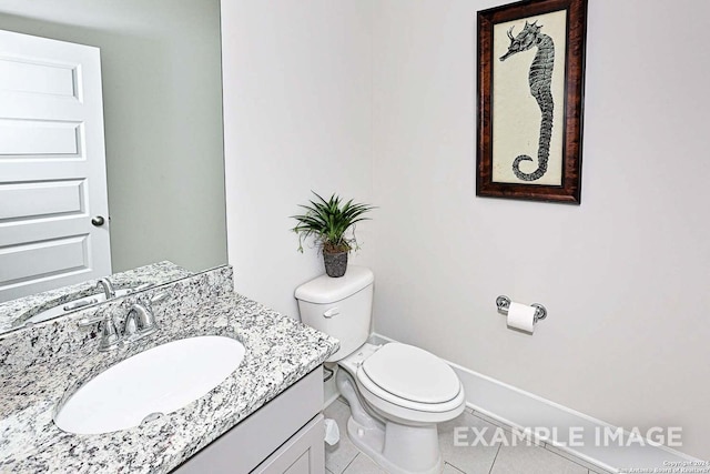 half bathroom with baseboards, vanity, tile patterned flooring, and toilet