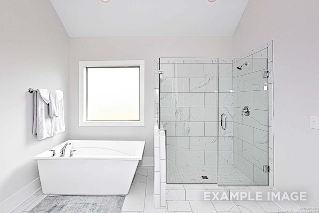 bathroom featuring separate shower and tub and vaulted ceiling